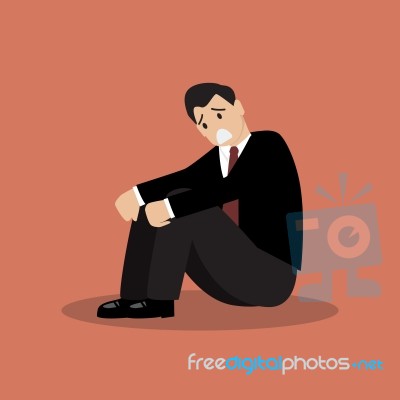 Desperate Businessman Sitting Alone Stock Image