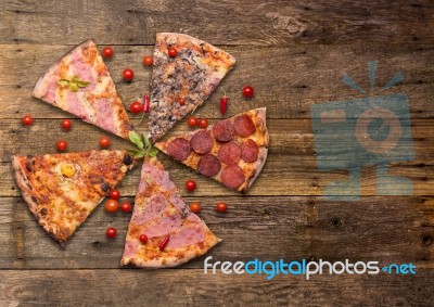 Diferents Types Of Pizza Cut On Wooden Table Stock Photo