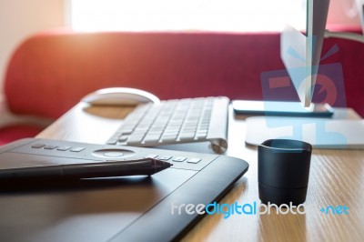 Digital Drawing Tablet And Computer On The Desk Stock Photo