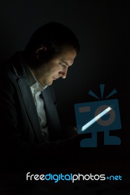 Digital Tablet In The Dark Stock Photo