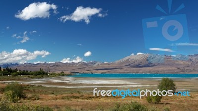 Distant View Of Lake Tekapo On A Summer's Day Stock Photo