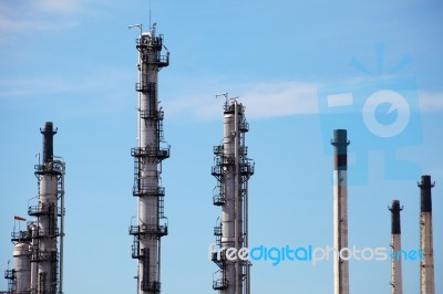 Distillation Towers And Smokestacks On Blue Sky Background Stock Photo