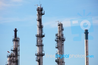 Distillation Towers On Blue Sky Background Stock Photo