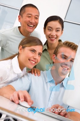 Diverse Group Of Happy People Looking Computer Stock Photo