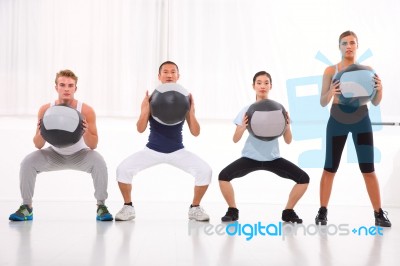 Diverse Group Of People Exercising With Pilates In Gym Stock Photo