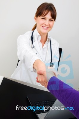 Doctor And Patient Shaking Hands Stock Photo