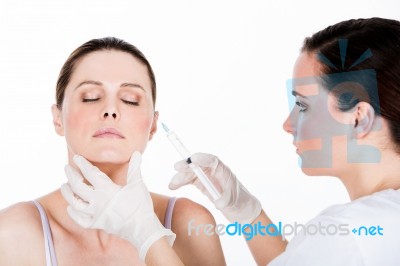 Doctor Gets Botox Injection To A Woman Patient Stock Photo