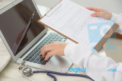 Doctor Hands Typing On Laptop Keyboard Stock Photo