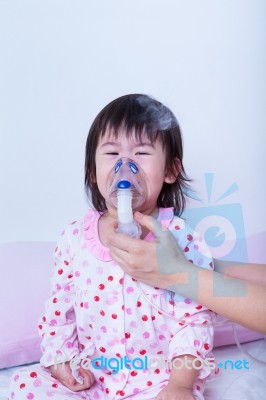 Doctor Helps Little Girl To Do Inhalation Stock Photo