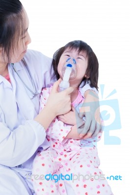 Doctor Helps Little Girl To Do Inhalation Stock Photo