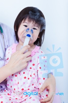 Doctor Helps Little Girl To Do Inhalation Stock Photo