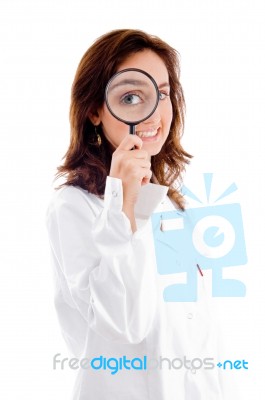 Doctor Holding Magnifier Close To Eyes Stock Photo