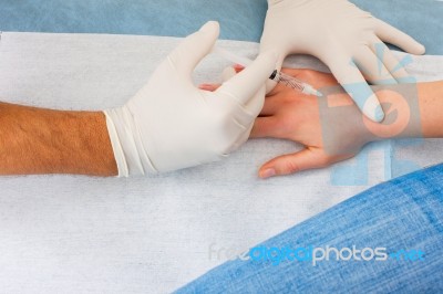 Doctor Injecting A Patient Stock Photo