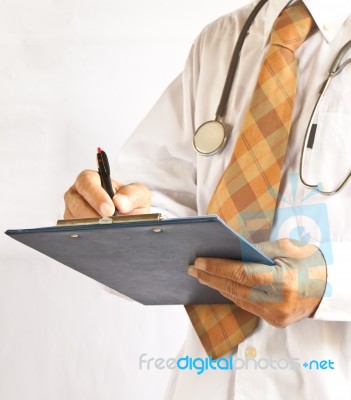 Doctor Writing On Pad Stock Photo