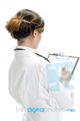 Doctor Writing On Paper Stock Photo