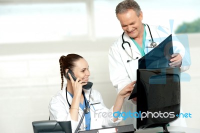 Doctors Reviewing Patients X-ray Report Stock Photo