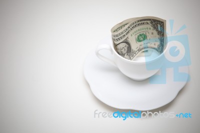 Dollars In White Coffee Cup Stock Photo