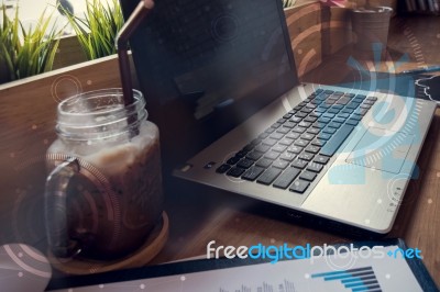 Double Exposure Of Computer On The Table Inside Coffee Shop Stock Photo