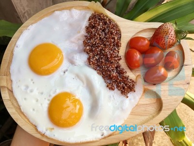 Double Fried Eggs With Brown Quinea Stock Photo