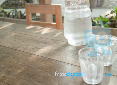 Double Glasses Of Cold Water On Wooden Table Stock Photo