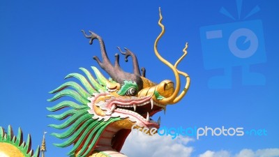 Dragon Statue Under Blue Dragon Sky Stock Photo