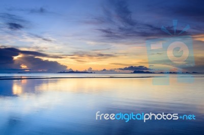 Dramatic  Beach  Sunset With Colorful Sky Background Stock Photo