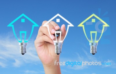 Drawing House Model On Light Bulb Stock Photo