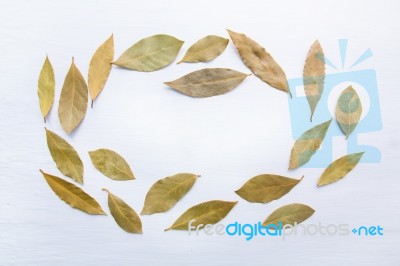 Dried Bay Leaves On White Wooden Background Stock Photo