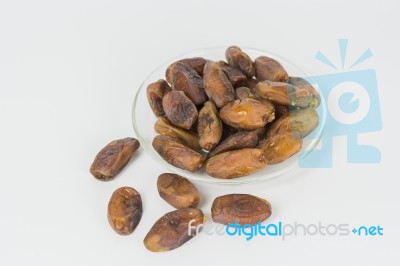 Dried Dates In The Dish On White Background Stock Photo