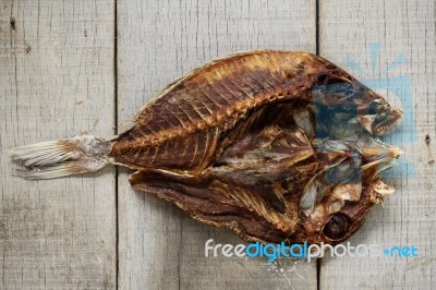 Dried Fish On Wooden Stock Photo