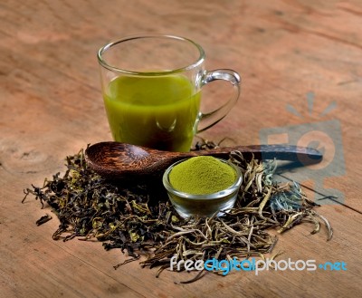 Dried Tea Leaf And Powder With Glass On Wood Stock Photo