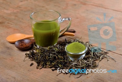 Dried Tea Leaf And Powder With Glass On Wood Stock Photo