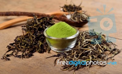 Dried Tea Leaf And Powder With Spoon On Wood Stock Photo