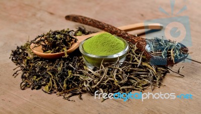 Dried Tea Leaf And Powder With Spoon On Wood Stock Photo