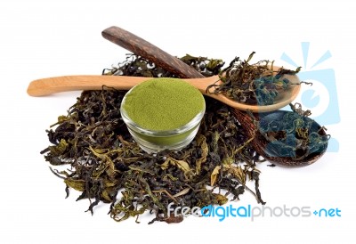 Dried Tea Leaf And Powder With Wooden Spoon Stock Photo