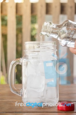 Drinking Water Is Poured Into Iced Glass Stock Photo