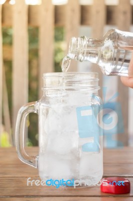 Drinking Water Is Poured Into Iced Glass Stock Photo