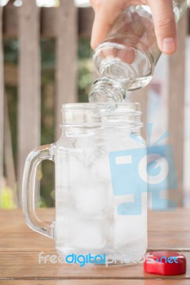 Drinking Water Is Poured Into Iced Glass Stock Photo