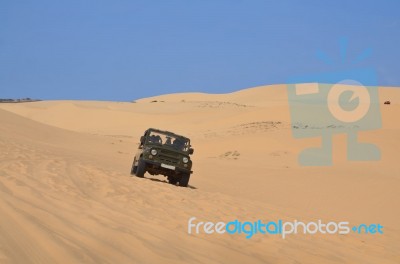 Driven Jeep Car On Desert Stock Photo