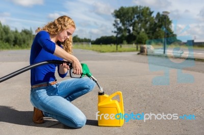 Dutch Woman Fueling Jerrycan With Petrol Hose Stock Photo