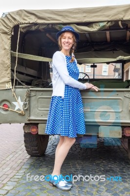 Dutch Woman Standing Against Military Jeep Stock Photo