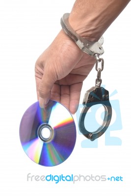 Dvd In Hand  With Handcuffs Stock Photo