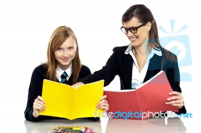 Educator Sitting With A Student And Taking Her Through A Lesson Stock Photo