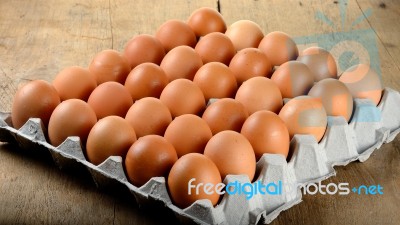 Egg In Packet On Wooden Background Stock Photo