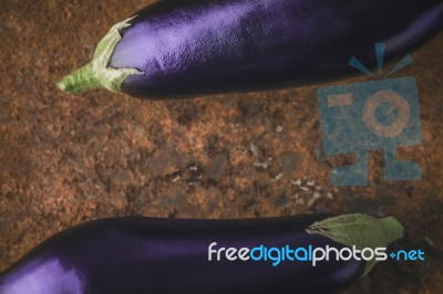 Eggplants On The Brown Stone Background  Horizontal Stock Photo