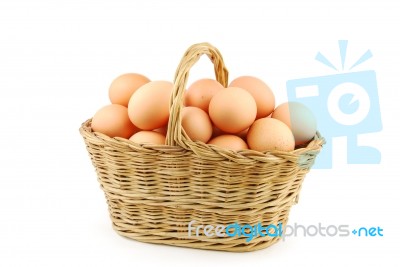 Eggs In A Wicker Basket On White Stock Photo