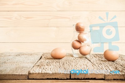 Eggs In Glass On Old Wooden Table Stock Photo