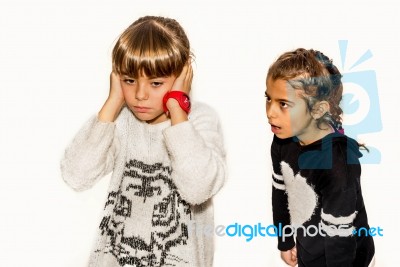 Eight Year Old Girl Being Angry And Shouting At Her Sister. Isolated On White Stock Photo