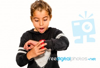 Eight Year Old Girl Looking At Her Watch Surprised At What Time It Is Stock Photo