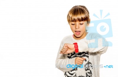 Eight Year Old Girl Looking At Her Watch Surprised At What Time It Is Stock Photo